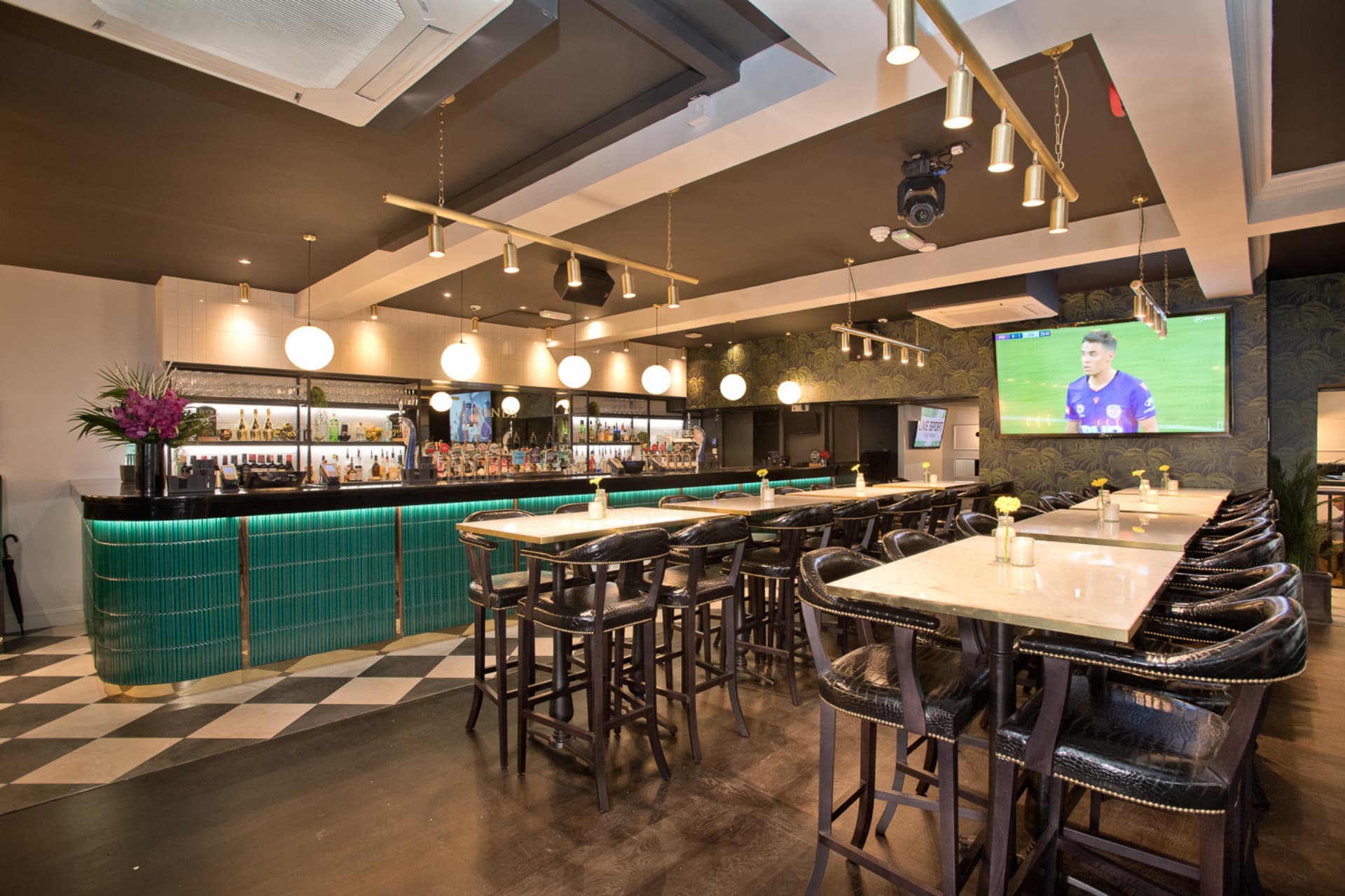 Main bar area with high table seating and big screen